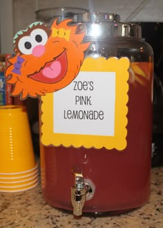 a jar with some kind of pink lemonade in it sitting on a counter top