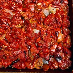 a pan filled with cooked red peppers and onions