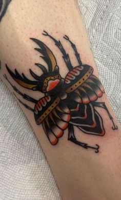 a tattoo on the arm of a person with an insect design on it's arm