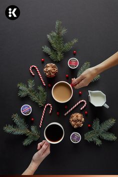 two people holding hands over coffee and candy canes