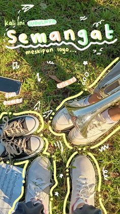 someone's feet and shoes are on the ground with writing in front of them