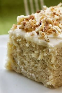 a close up of a piece of cake on a plate with a fork in the background