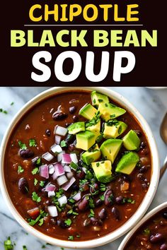 two bowls filled with black bean soup and topped with avocado