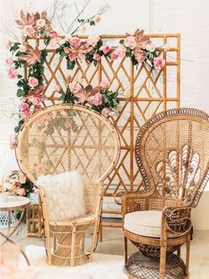 two wicker chairs and one chair with flowers on the wall in front of them