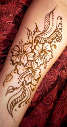 a woman's arm with henna tattoos on it