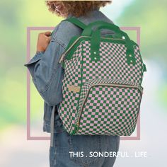 a woman carrying a green and white checkered backpack with her back to the camera