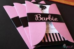 three pink and black folded cards with the name barbie on them