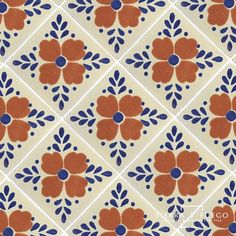 an orange and blue flower pattern on a white tile