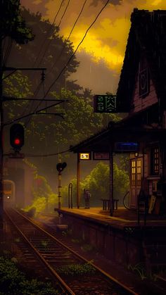 a train station at night with the lights on and trees in the foreground,