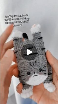 someone holding up a small crocheted cat cell phone case with the caption