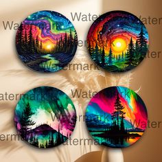 three coasters with the image of trees and mountains painted in bright colors on them