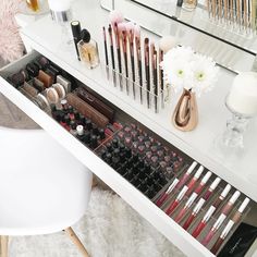 a vanity with makeup and flowers on it