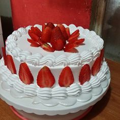 there is a white cake with strawberries on top