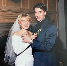 a bride and groom pose for a photo