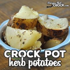 a bowl filled with potatoes sitting on top of a wooden table