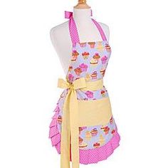 a woman wearing an apron with cupcakes on it