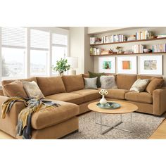 a living room scene with focus on the couch and coffee table in front of the window