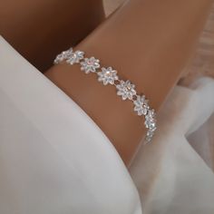 Add a touch of elegance and sophistication to your bridal ensemble with our exquisite non-slip bridal garter adorned with pearl flowers and artificial diamond accents. Crafted with meticulous attention to detail, this garter combines delicate beauty with practicality, ensuring a secure and comfortable fit throughout your special day. Whether you're walking down the aisle or dancing the night away, our garter promises to add a touch of glamour to every moment. Elevate your wedding day attire with Rhinestone Garter, Garter Wedding, Pearl Flowers, Wedding Garters, Delicate Beauty, Bridal Garter, Wedding Garter, Rhinestone Wedding, Timeless Accessories