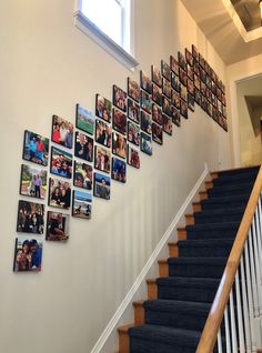 a staircase with pictures on the wall and photos hanging on the wall next to it