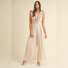 This Stunning Jumpsuit Features Solid Satin Fabric With Intricate 3d Floral Appliques On The Front, Creating A Beautiful And Eye-Catching Look. The Deep Cowl Neck And Open Back Add A Touch Of Allure And Sophistication To The Design. The Wide Leg Silhouette Offers A Flattering And Elegant Silhouette. The Back Self-Tie Detail Closure Adds A Unique And Stylish Element To The Jumpsuit. Elevate Your Evening Attire With This Chic And Standout Piece That Is Sure To Make A Statement. Features: Tied, Ruc Cowl Neck Jumpsuit, Satin Jumpsuit, Floral Applique, Evening Attire, Wide Leg Jumpsuit, Satin Fabric, Quality Clothing, Cowl Neck, Appliques