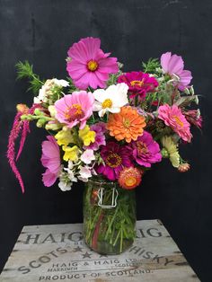 a vase filled with lots of colorful flowers