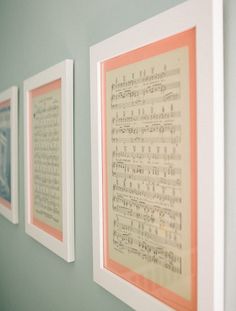 three framed sheet music pieces hanging on the wall next to each other in a row