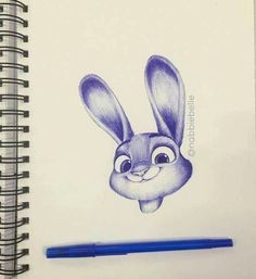 a pencil drawing of a rabbit with eyes wide open and ears straight up, sitting next to a blue pen