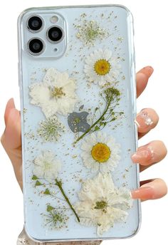 a person holding up a phone case with flowers on the front and back cover in their hands