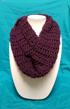 a purple crocheted cowl on a white mannequin