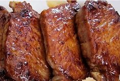 four pieces of meat sitting on top of a white plate