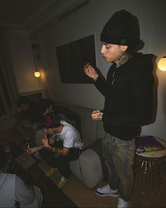 a man standing in a living room eating food