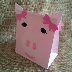 a pink paper bag with a pig face on it