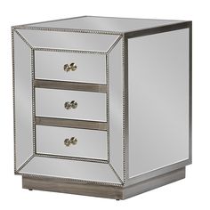 a mirrored cabinet with three drawers and two knobs