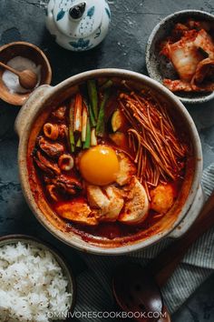 an overhead view of a bowl of food with rice, meat and egg in it