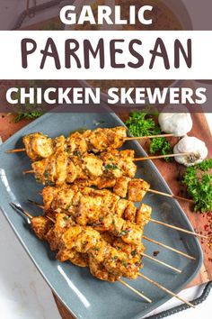 garlic parmesan chicken skewers on a blue plate with text overlay