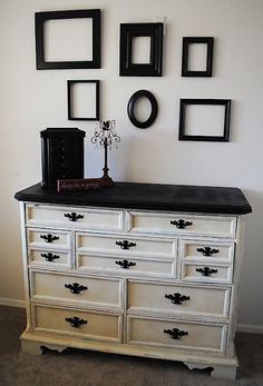 an old dresser has been painted white and black