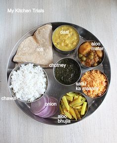 a metal plate topped with different types of food