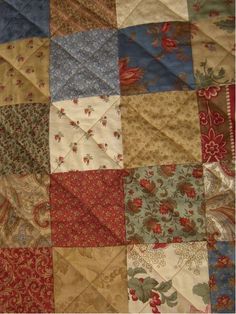 an old quilt with many different colors and patterns