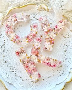 the letters are made out of flowers on a doily