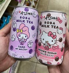 two cans of hello kitty drink are shown