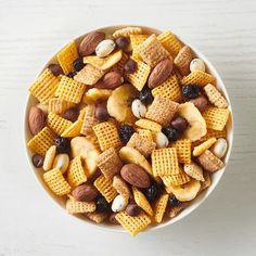 a bowl filled with cereal and nuts on top of a table