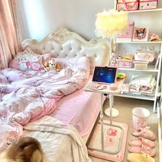 a bed room with a laptop on top of it next to a shelf filled with toys