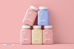 four bottles of smoothie on a pink background