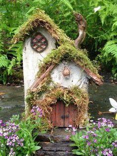 a birdhouse with moss growing on it's roof