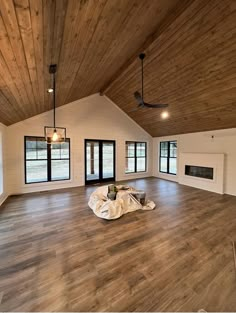 an empty living room with wood floors and exposed ceiling beams is pictured in this image