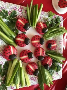 ladybugs and celery are arranged on a platter