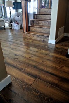 a wooden floor in a house with stairs