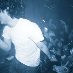 a man standing in front of a crowd at a concert