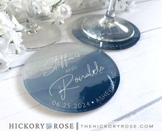 two personalized wine glasses sitting next to each other on top of a white table