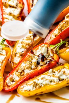 stuffed bell peppers with feta cheese and olives on the side are ready to be eaten